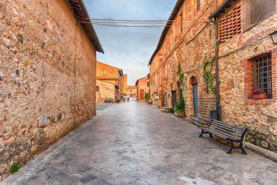 Empty alley amidst buildings in city