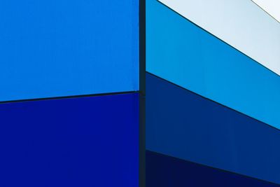 Low angle view of modern building against blue sky