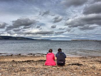 Rear view of man looking at sea
