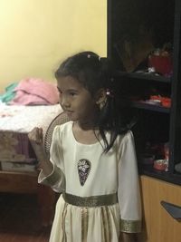 Teenage girl looking away at home