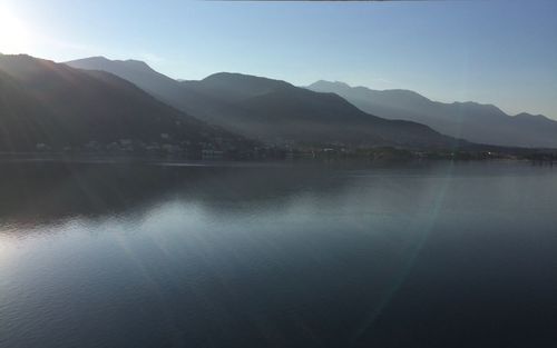 Scenic view of lake and mountains against clear sky