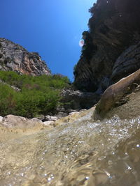 Scenic view of rocks in sea against clear sky