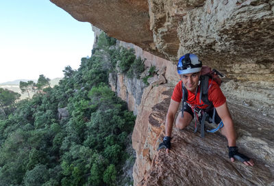 Rear view of man climbing on mountain