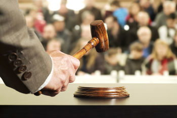 Close-up of judge hammering on gavel in court
