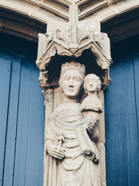 Low angle view of statue against wall