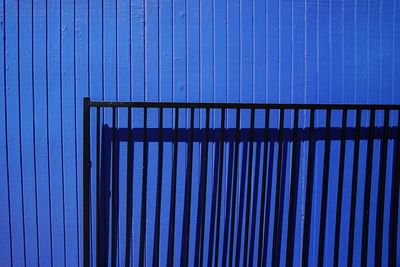 Low angle view of metallic structure against blue sky