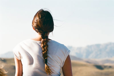 Rear view of woman standing against clear sky