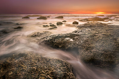 Scenic view of sea against sky at sunset