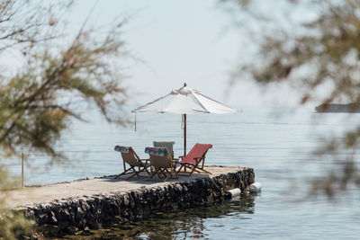 Deck chairs and sun shade at the ocean