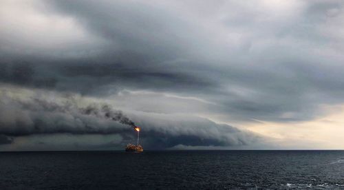 Scenic view of sea against dramatic sky