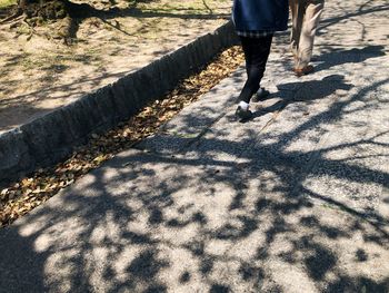 Low section of men walking on footpath