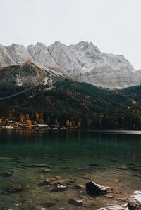 Scenic view of lake and mountains against clear sky