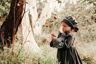 Full length of boy holding apple on land