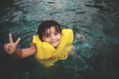 Portrait of smiling boy swimming in pool