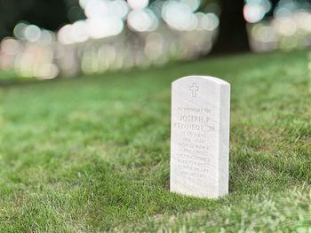 Close-up of text on grass in field