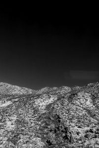 Scenic view of snow covered land against clear sky