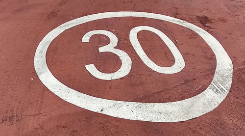 Close-up of arrow sign on road