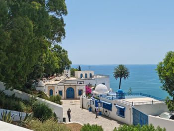 View of swimming pool by sea against sky