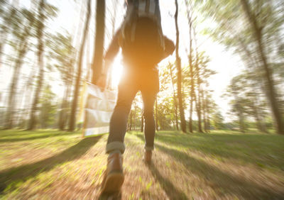 Rear view of woman running in forest