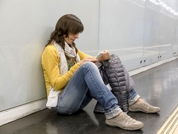 Side view of woman using mobile phone