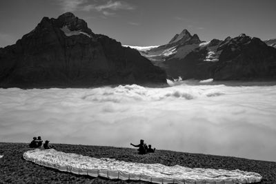 Paragliding in front of snowcapped mountains in swiss alps