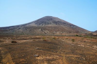 Scenic view of arid landscape against clear sky