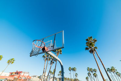 Low angle view of basketball hoop against blue sky