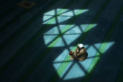 High angle view of woman sitting on floor