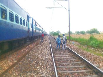 People walking on railroad track