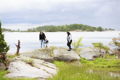 Family with toddler on walk at lake