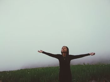 Full length of man standing on field against sky