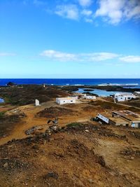 Scenic view of beach against blue sky