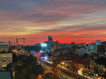 High angle view of illuminated buildings against sky at sunset