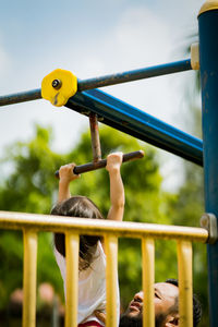 Low angle view of boy playing in playground