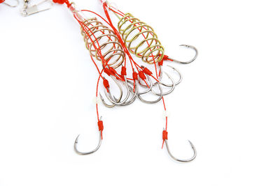 High angle view of fishing hook on white background
