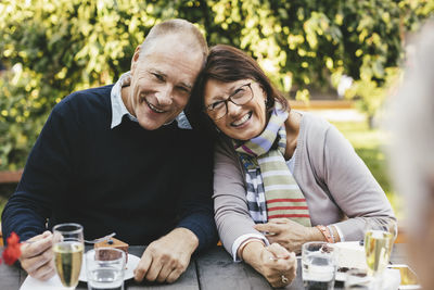 Portrait of loving senior couple having desserts at cafe table