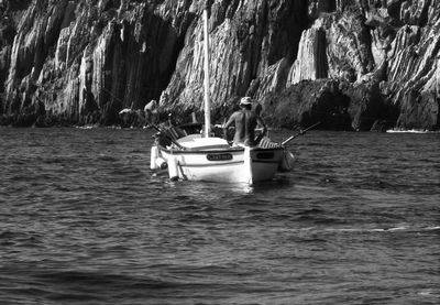 Boats in water against trees