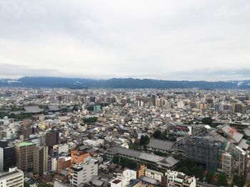 Cityscape against cloudy sky