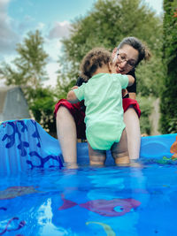 Full length of smiling girl in swimming pool