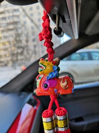 Close-up of multi colored decoration hanging in car