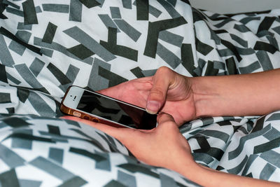Midsection of person using mobile phone