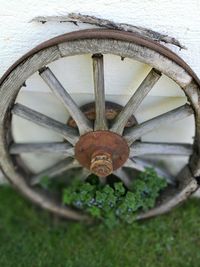 Close-up of rusty wheel on field