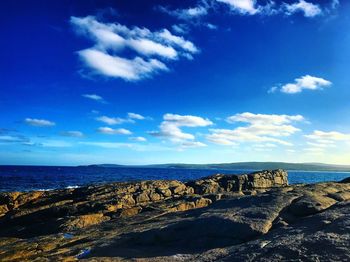 Scenic view of sea against blue sky