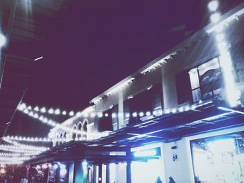 Low angle view of illuminated bridge at night