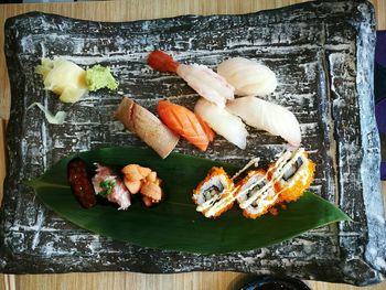 Sashimi with sushi on tray