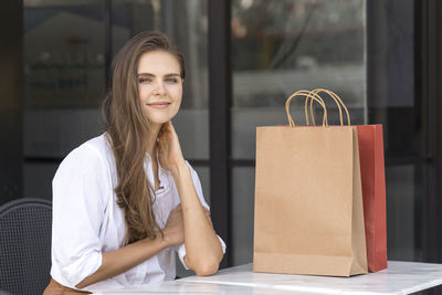 Portrait of young woman sitting outdoors