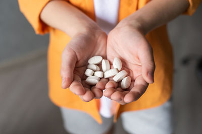 Cropped hand holding pills
