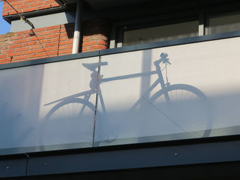 Low angle view of bicycle against building