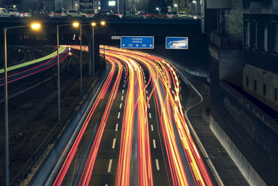 High angle view of light trails on highway at night