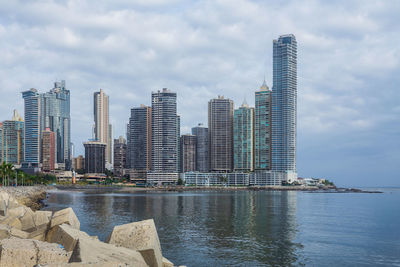 View of skyscrapers against cloudy sky